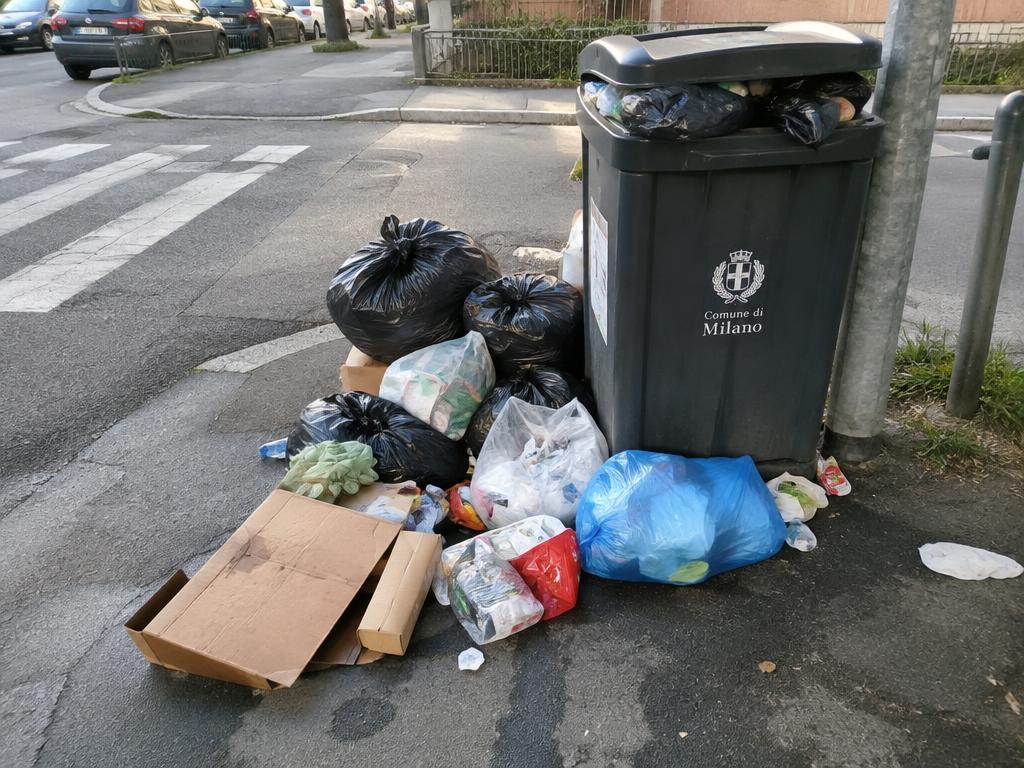 Overflowing garbage bins on street corner